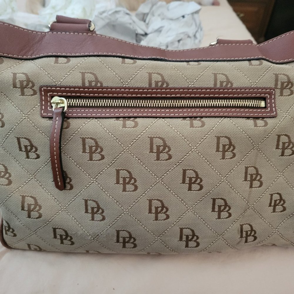Dooney & Bourke purse in tan and brown with large red compartment
